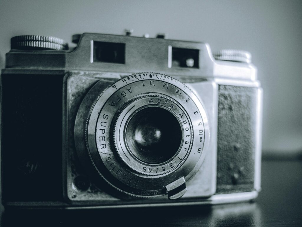 Close-up of a classic analog camera in black and white, showcasing vintage elegance.